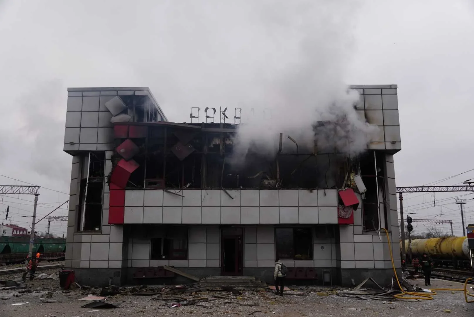 Зруйнований другий поверх вокзалу з димом, уламками та коліями